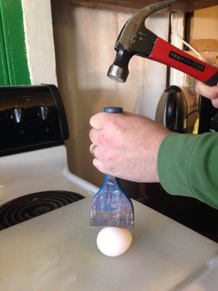 using a chisel to crack open a hard-boiled egg
